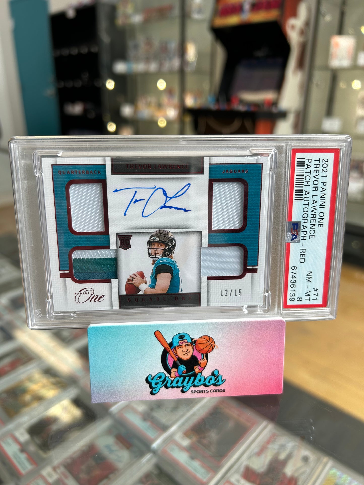 2021 Panini One Trevor Lawrence RC Patch Auto Red /15 PSA 8